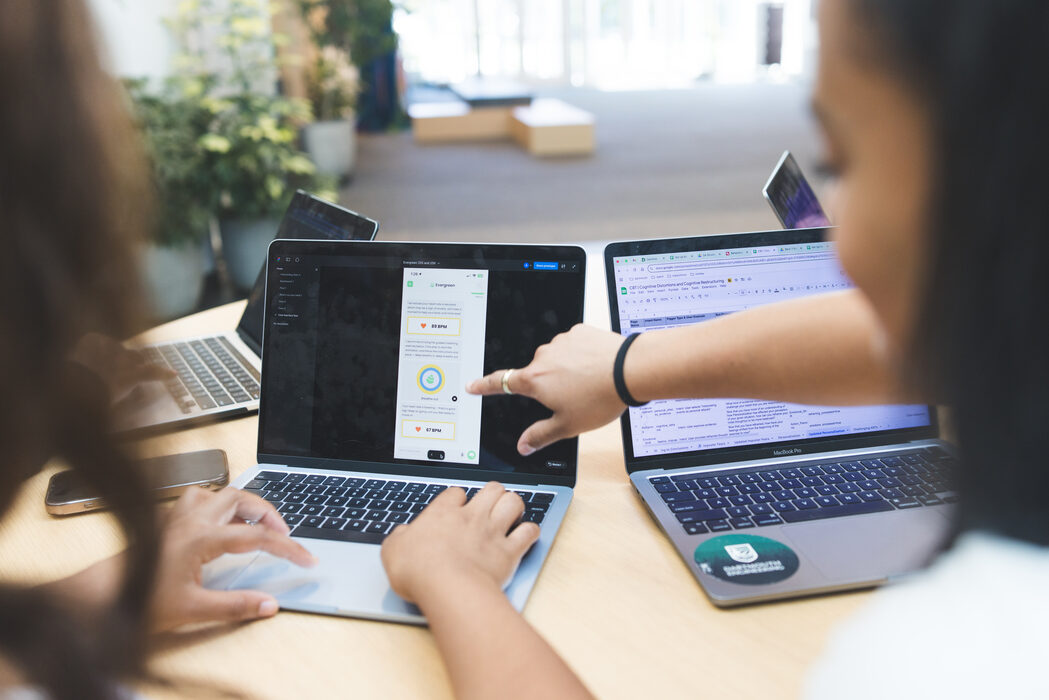 A student pointing out a detail of the Evergreen app on a laptop screen