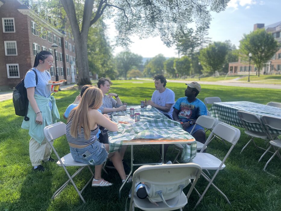 The team sharing a picnic table at the summer wellness party