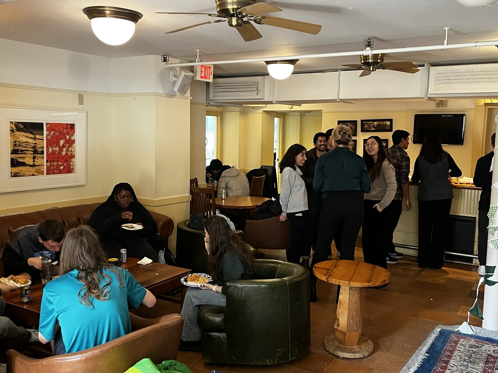 Evergreen team members sharing food and conversation at the Spring Social in Collis One Wheelock