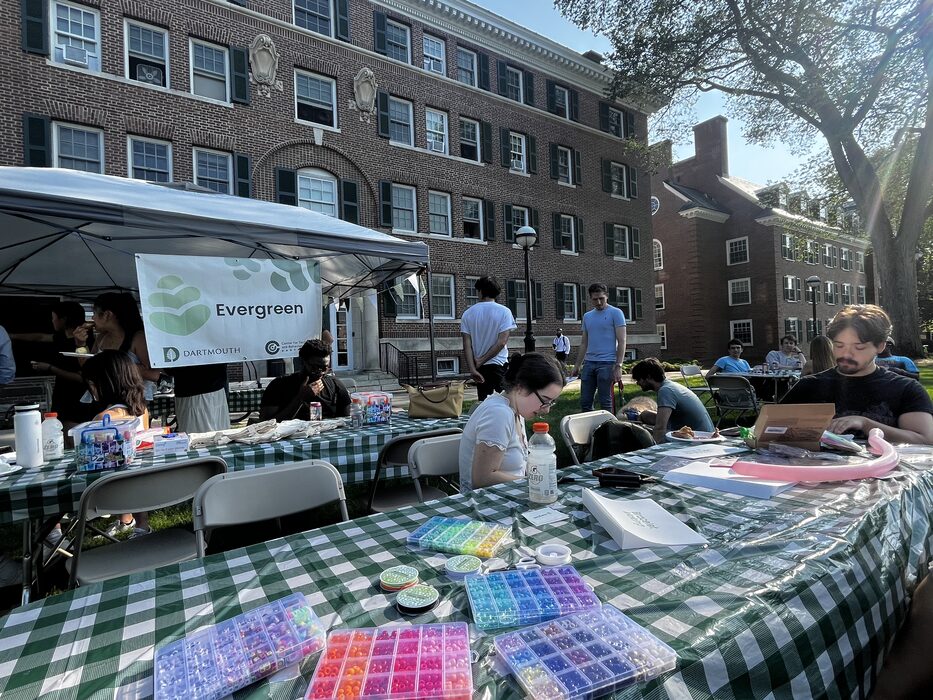 Freshly tie-dyed shirts drying on a picnic table at the summer wellness party